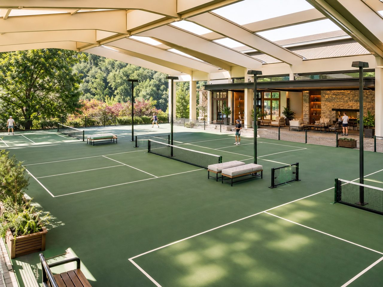 Multiple covered forest-green pickleball courts beside a player lounge
